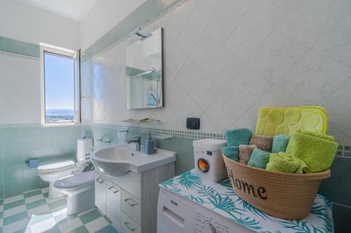 a bathroom with a sink and a toilet at A Casa Mia in Floridia