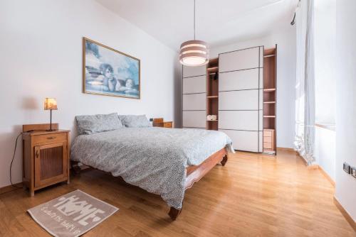 a bedroom with a bed and a wooden floor at Appartamento Ania vista castello in Tenno