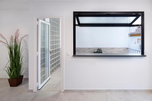 a mirror in a white room with a window at El Monte in Cómpeta