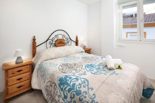 a bedroom with a bed and a window at El Monte in Cómpeta
