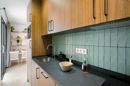 a kitchen with a sink and a counter top at Dreaming Penthouse Mogan in Mogán