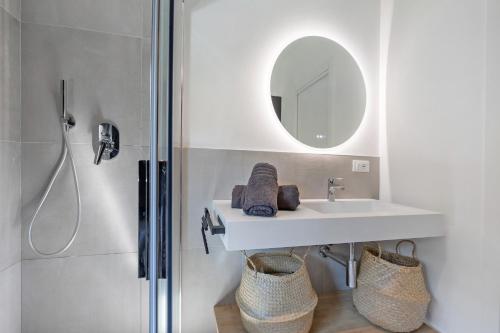a bathroom with a sink and a shower at Villa Luma with private Pool in Lazise
