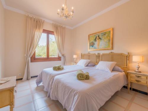a bedroom with two beds with towels on them at Villa Torre in Cala Santanyi