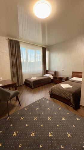 a hotel room with two beds and a large window at Відпочинковий - комплекс '"Замок Лева"" in Peremyshlyany