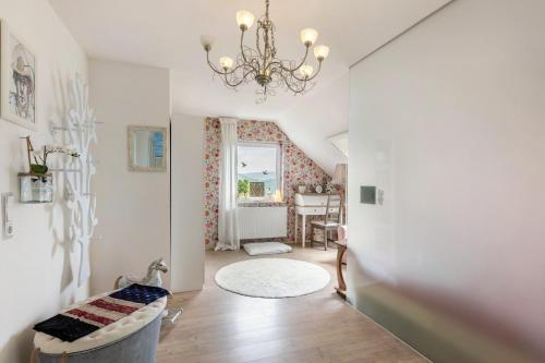 a hallway with a chandelier and a living room at Ferienwohnung Am Jakobsweg in Schmallenberg