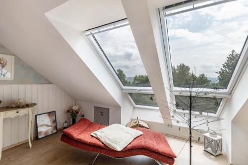 a bedroom with a bed and two windows at Ferienwohnung Am Jakobsweg in Schmallenberg