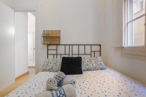 a bedroom with a bed and a large window at Cozy Apartment Blanes in Blanes