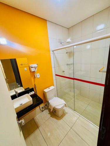 a bathroom with a shower and a toilet and a sink at Boulevard Park Hotel in São Luís