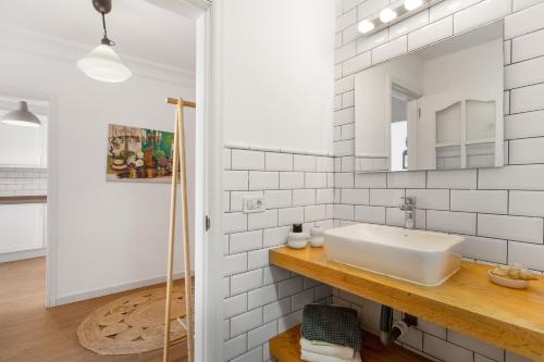 a white bathroom with a sink and a mirror at Atlantic Nomad Retreat in Puerto del Rosario