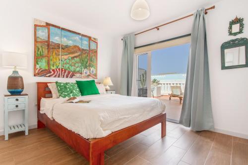 a bedroom with a bed and a view of the ocean at Atlantic Nomad Retreat in Puerto del Rosario
