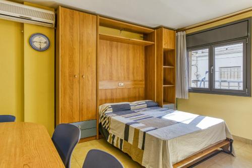 a bedroom with a bed and a table and chairs at Estudio P in L'Escala