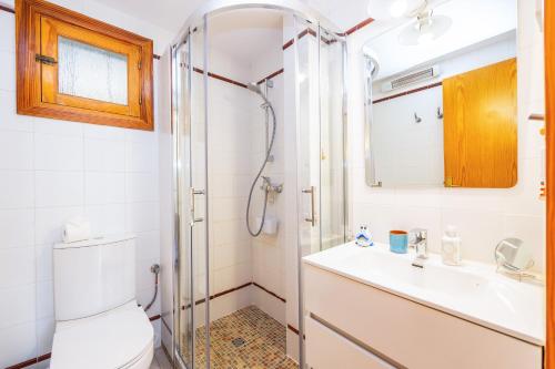 a bathroom with a shower and a toilet and a sink at Traumblickwohnung Montemar 19 in Sóller