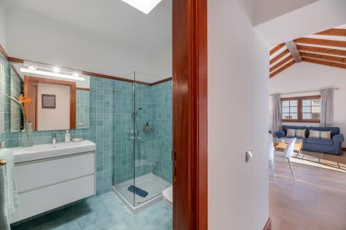 a bathroom with a sink and a glass shower at Villa Turqué in Arrieta
