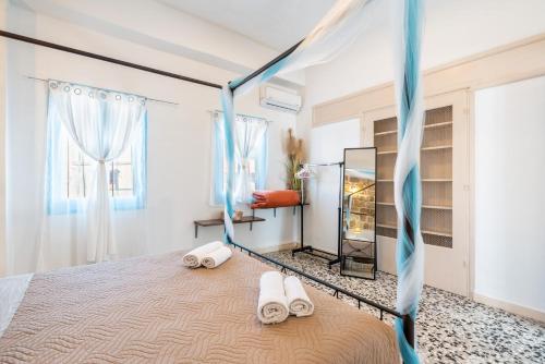 a bedroom with a bed with two white towels at Katia's Home in Rhodes Town