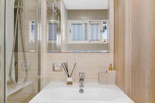 a bathroom with a sink and a shower at Los Molinos 202 in Maspalomas