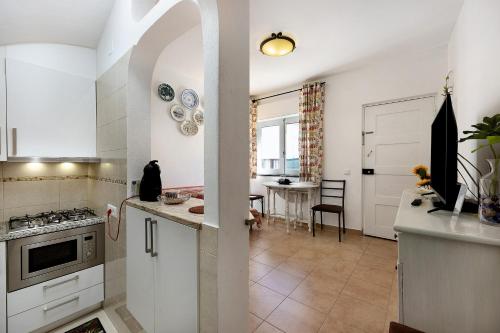 a kitchen with a black cat sitting on the counter at Mdc - Muralhas da Cidade in Lagos