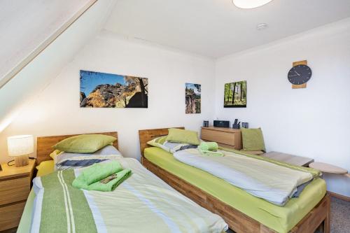 two beds in a room with white walls at Gohrischblick in Kurort Gohrisch