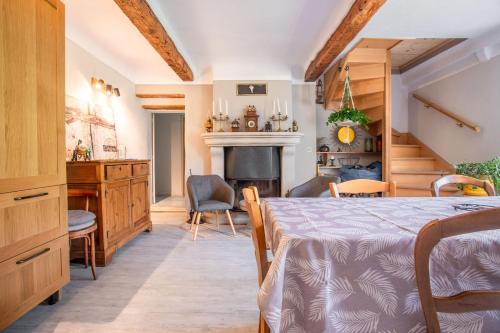 a bedroom with a bed and a desk and a fireplace at Appart Authentique et Confortable in Valderoure
