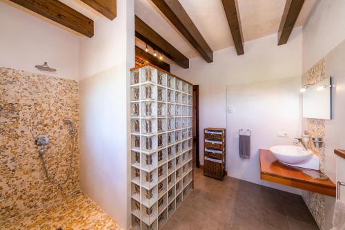 a bathroom with a toilet and a sink and a shower at Finca Can Simonet in Santanyi