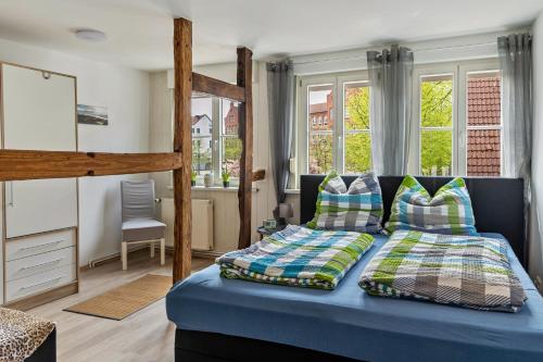 a bedroom with a bed with blue sheets and pillows at Ferienhaus Salzwedel in Salzwedel