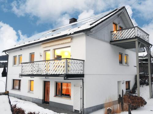 a white house with a balcony at Haus Wanderglück in Schmallenberg