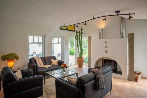 a living room with two couches and a fireplace at Ferienhaus Wennetraum mit Sauna in Eslohe