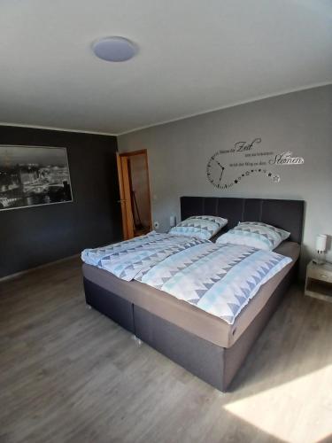 a bedroom with a large bed in a room at Ferienhaus Nosbers in Kleinlangenfeld