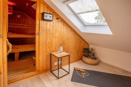 a attic room with a skylight and wooden walls at Ferienhaus Wennetraum mit Sauna in Eslohe