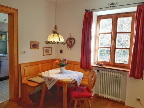 a dining room with a table and a window at Haus am Kurgarten - Seeberg in Bayrischzell