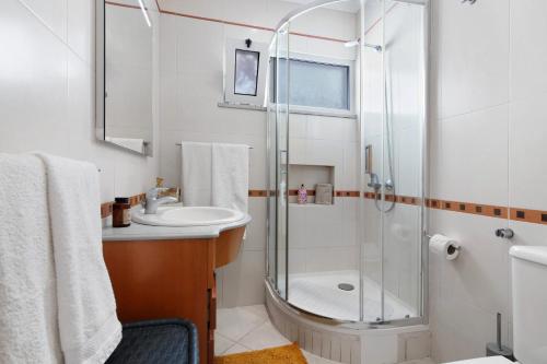 a bathroom with a shower and a sink at Casa Vista Mar in Albufeira