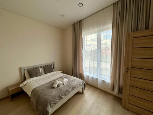 a bedroom with a bed with a stuffed animal on it at Raudondvaris holiday home in Raudondvaris