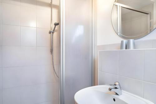 a bathroom with a shower and a sink and a mirror at Zimmer Edith in Gersfeld