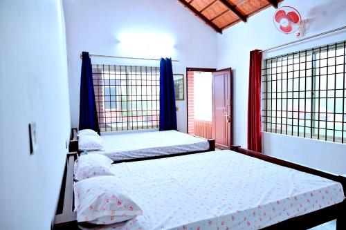 a bedroom with two beds and a window at Coffee Crown Homestay - 1km to Falls, Estate, Home Food in Sakleshpur