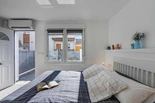a bedroom with a bed with two books on it at Loft A'ca La Puri en Melegís in Melegis
