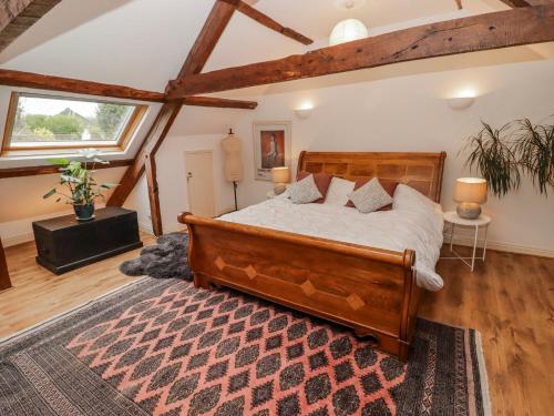 a bedroom with a wooden bed and a rug at The Secret Garden in Narberth