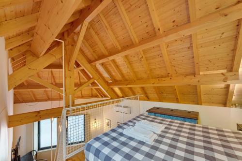 a bedroom with a large bed in a room with wooden ceilings at Orange Apartments B in Porto