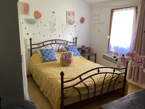 a bedroom with a bed with blue pillows at 196 rue des moulins in Vachères