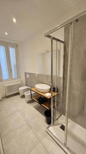 a bathroom with a sink and a shower and a toilet at CA' VARADE di Martina Scarduelli in Varallo