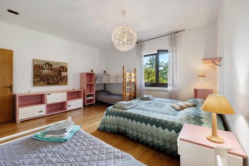 a bedroom with two beds and a table with a lamp at Alta Via Ligure - La Squazza in Bertigaro