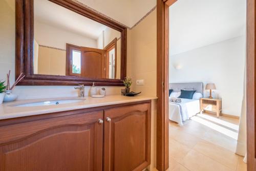 a bathroom with a sink and a mirror at Sa Lluna in Sant Josep