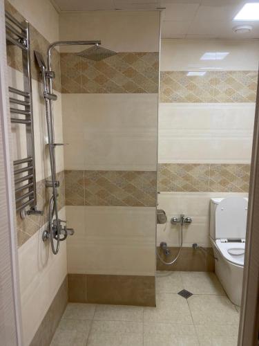a bathroom with a shower and a toilet at Cirag Hotel Kurdemir in Kyurdamir