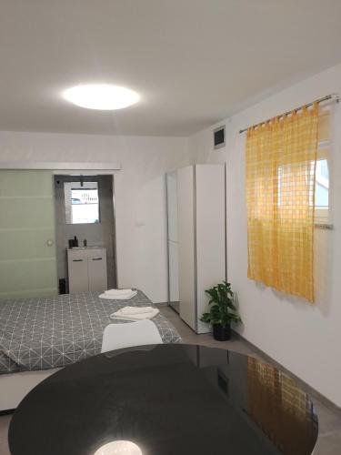 a room with two beds and a table in it at Lorber house Štinjan - Studio in Pula
