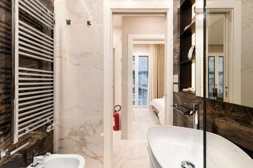 a bathroom with a white tub and a sink at Ginex Luxury Suite, Trani in Trani