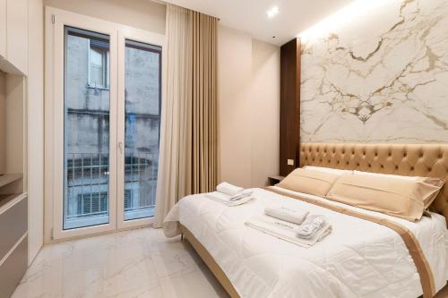 a bedroom with a large bed with a map on the wall at Ginex Luxury Suite, Trani in Trani