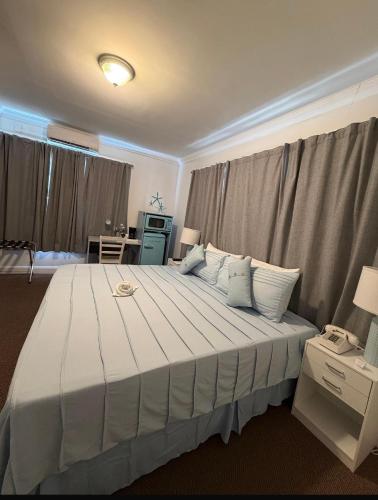a bedroom with a large bed with white sheets and pillows at Hotel Ponce de Leon in Miami