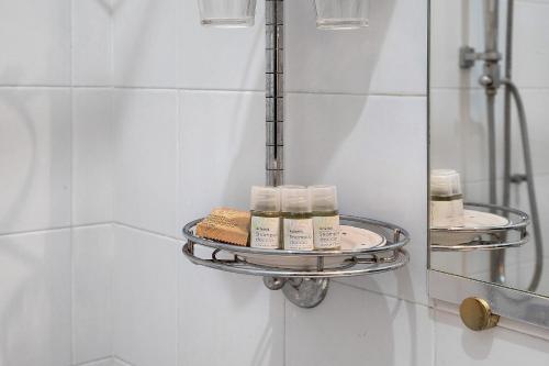 a shelf in a bathroom with some moisturizers on it at Biennale Apartment near San Marco in Venice