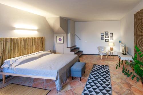 a bedroom with a large bed and a staircase at Gipsy Rose in Sarzana