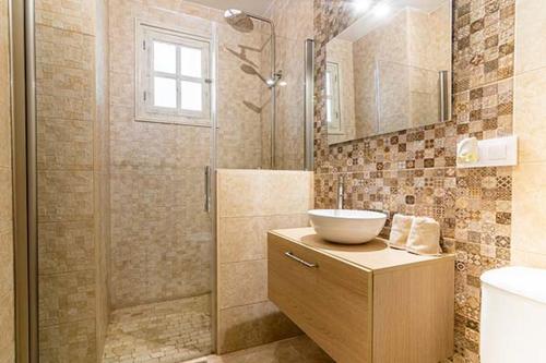 a bathroom with a shower and a sink and a toilet at Casa Jimena in Vejer de la Frontera