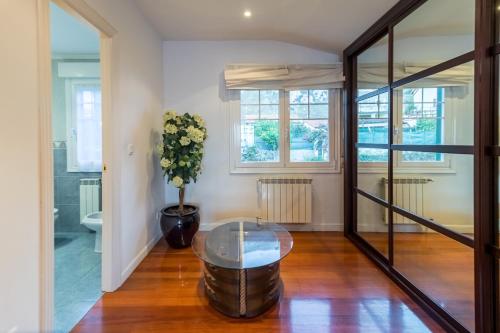 a living room with a glass table and a window at Villa La Perla De Sonabia in Oriñón