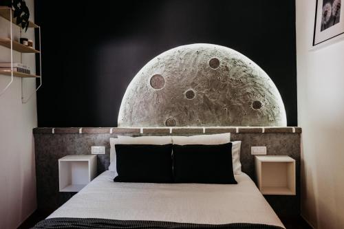 a bedroom with a bed with a moon mural on the wall at Casa Rural Kiko 2 in Icod de los Vinos
